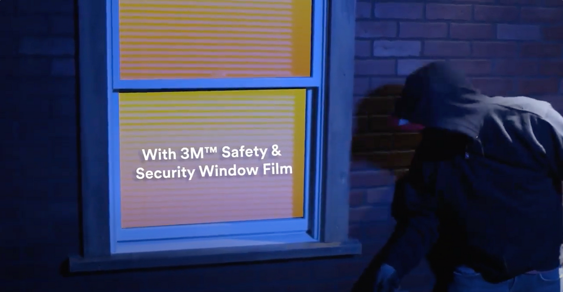 A window with 3M safety and security window film and an intruder attempting to break in