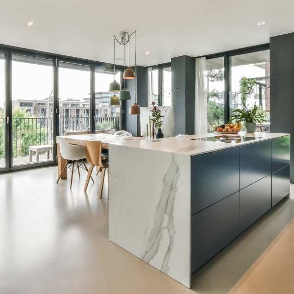 Residential kitchen, kitchen island and table with lots of windows