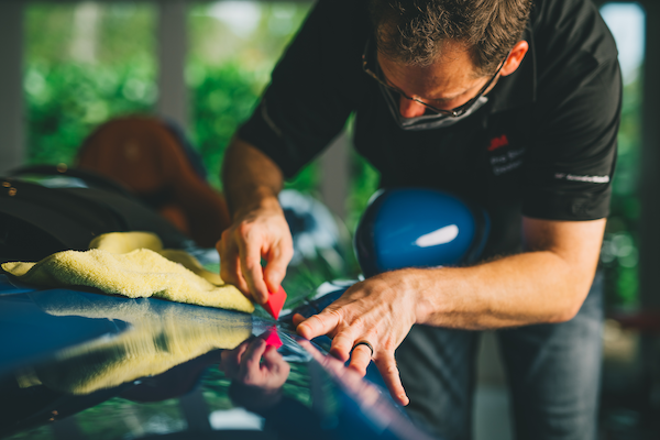 professional installation of paint protection film on a car hood 