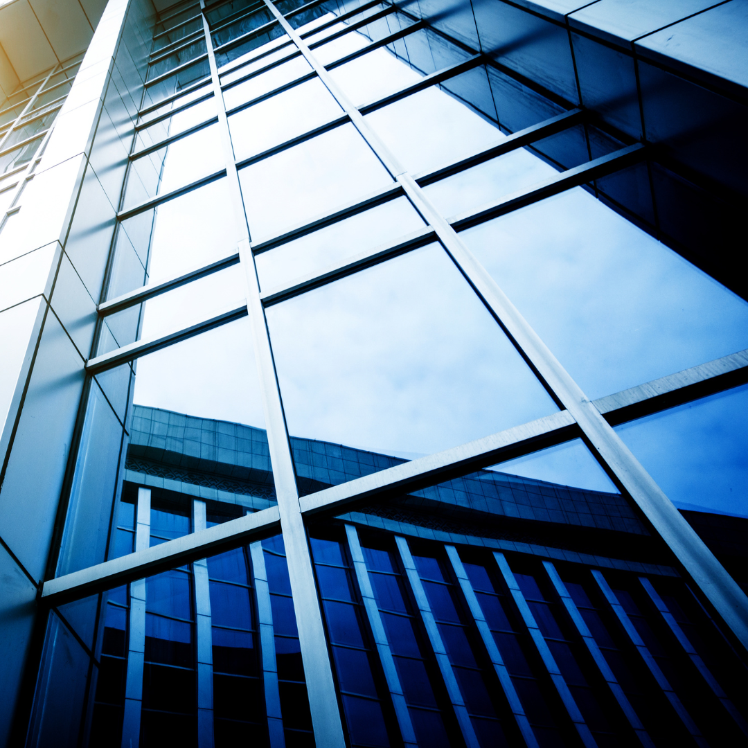 Silver P 18, outside of an office building, glass windows 